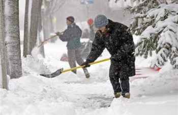 people shoveling snow on a snowy day