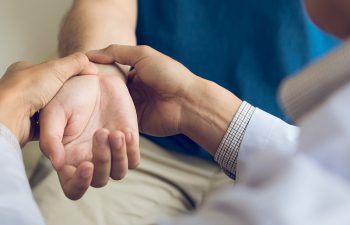 doctor examining a patient with wrist pain