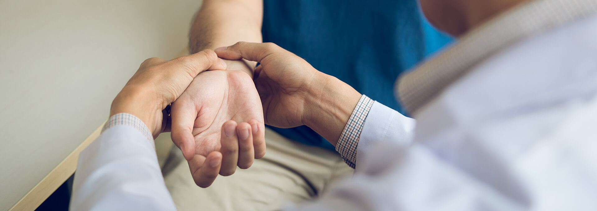 doctor examining a patient with wrist pain