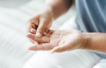 Woman suffering from hand and finger joint pain​.​ Causes of rheumatoid arthritis, carpal tunnel syndrome, gout. Health care and medical concept.