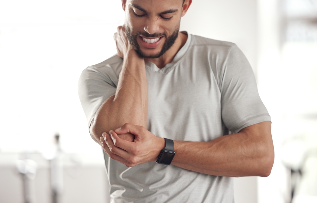 Fitness, stress and man with elbow pain for in gym for training, discomfort and joint problem. Frustrated, athlete and person with workout emergency for bursitis, inflammation and injury in exercise